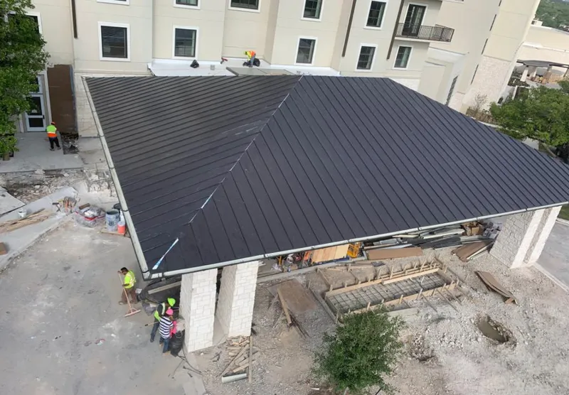 Metal roofing installation team working on a commercial building in Gulfport